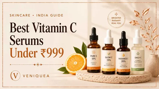 Row of vitamin C serum dropper bottles on an ivory surface with soft botanical shadows